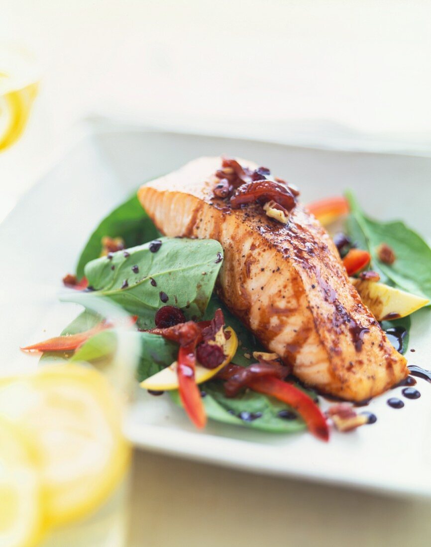 Seasoned Salmon Fillet Served Over a Baby Spinach Salad with Balsamic Dressing