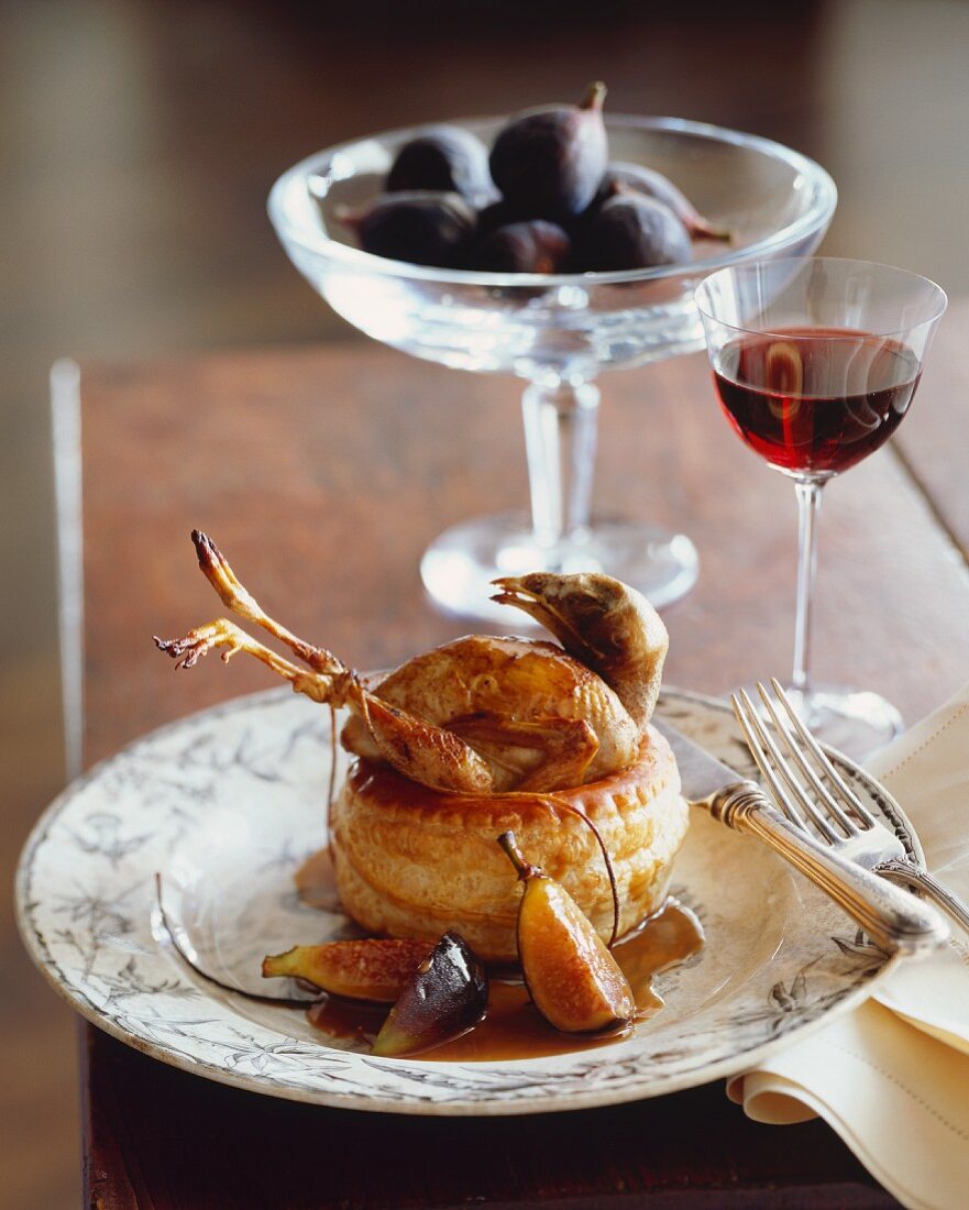 Whole Quail Cooked in Puff Pastry with Fig Sauce; Glass of Wine