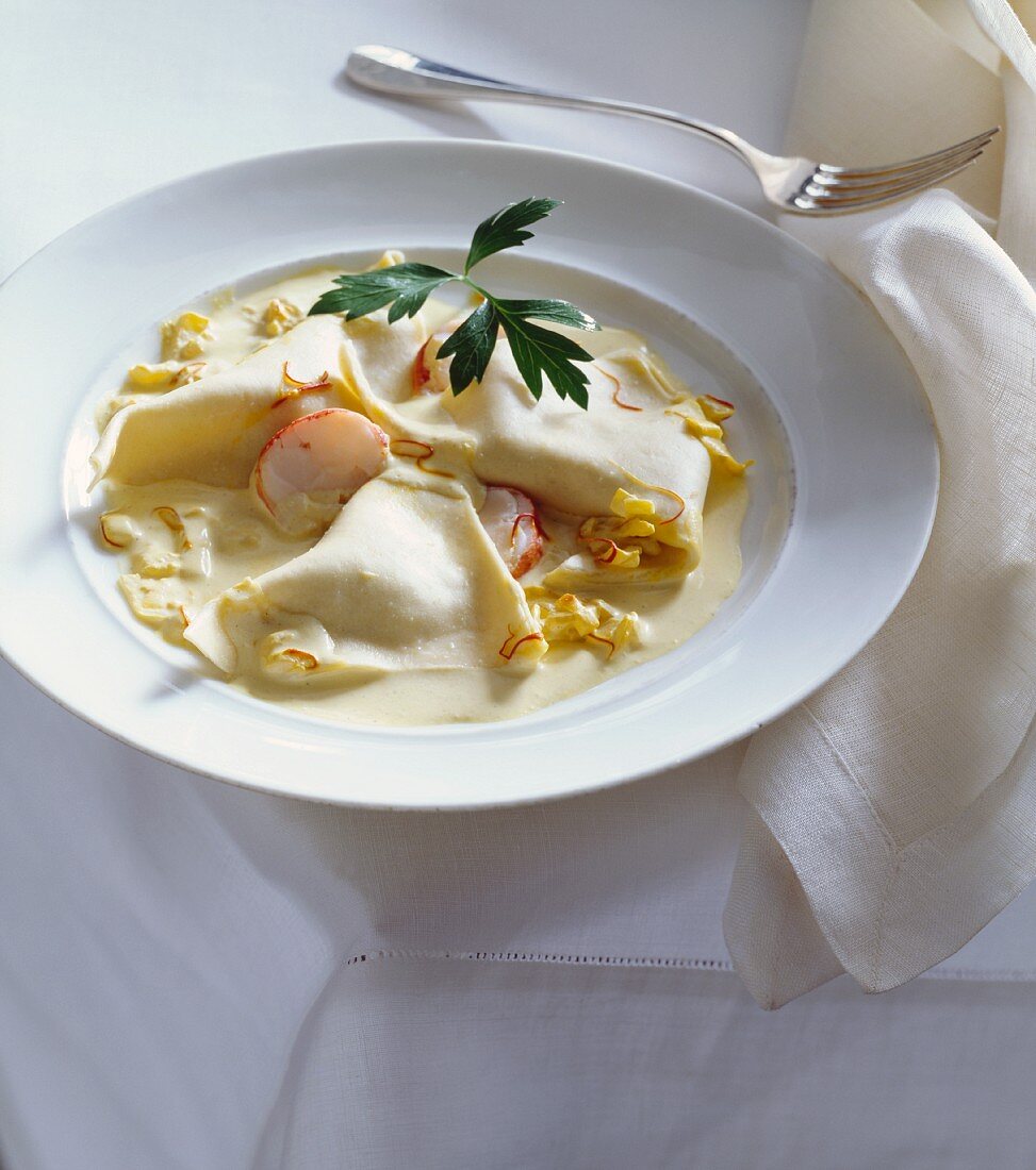 Fazzoletti Pasta in Cream Sauce; In a White Bowl with a Fork