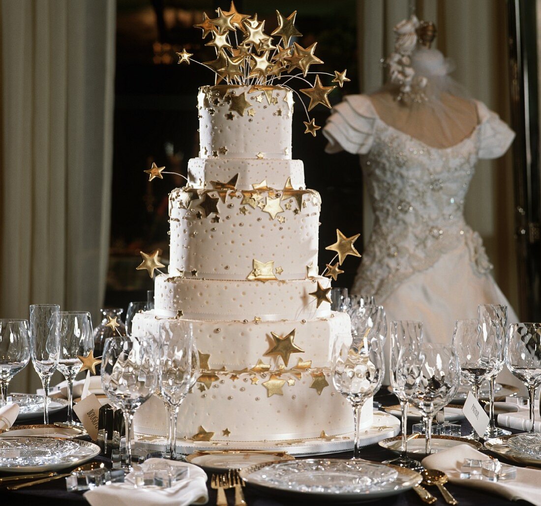 Tiered Wedding Cake with Gold Stars on a Set Table