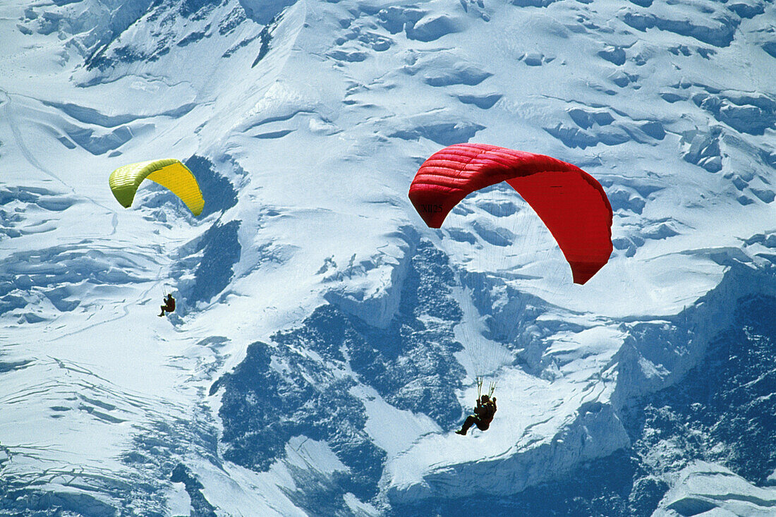 Two people paragliding at the mount Montblanc, Chamonix, France, Europe