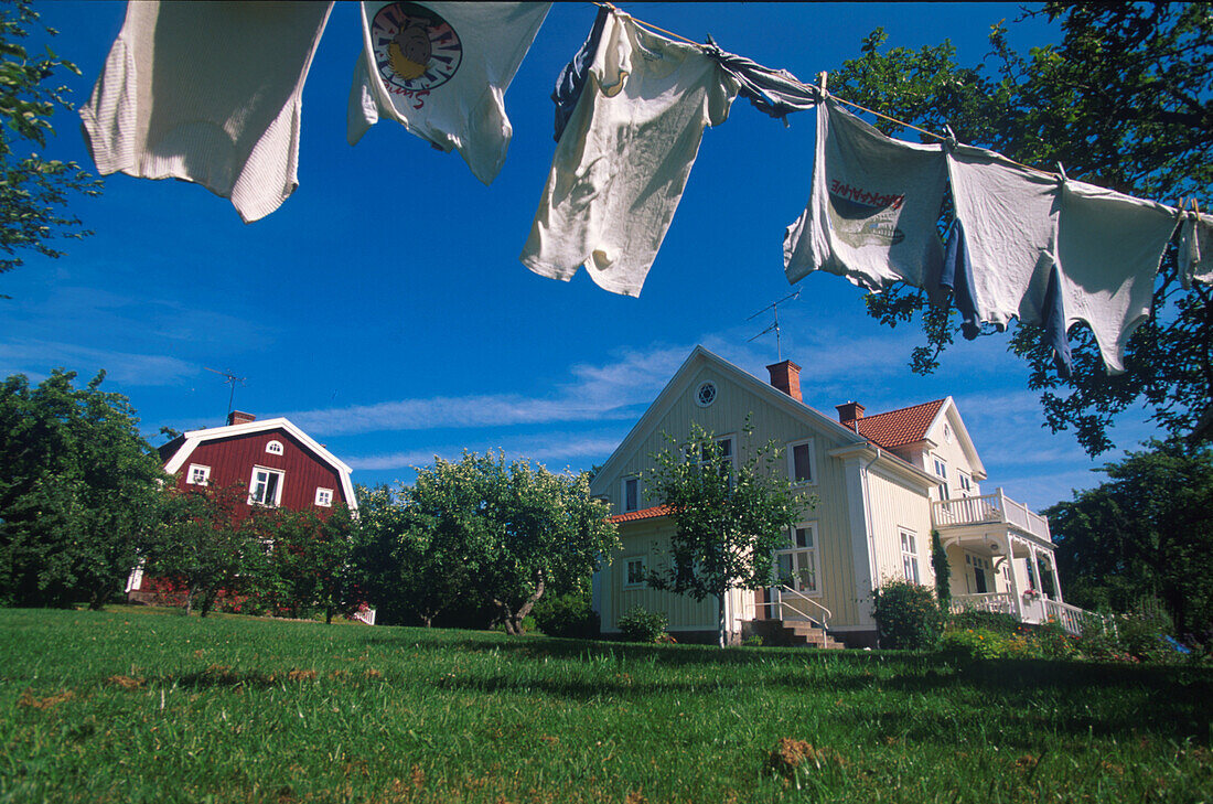 Clothesline and swedish summer residence in the sunlight, Sweden, Europe