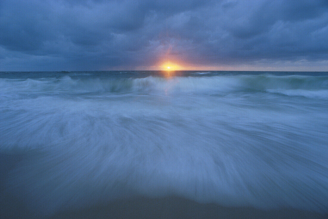 Sea view at sunset with breaking wave, Storm, North sea, Sylt, Germany