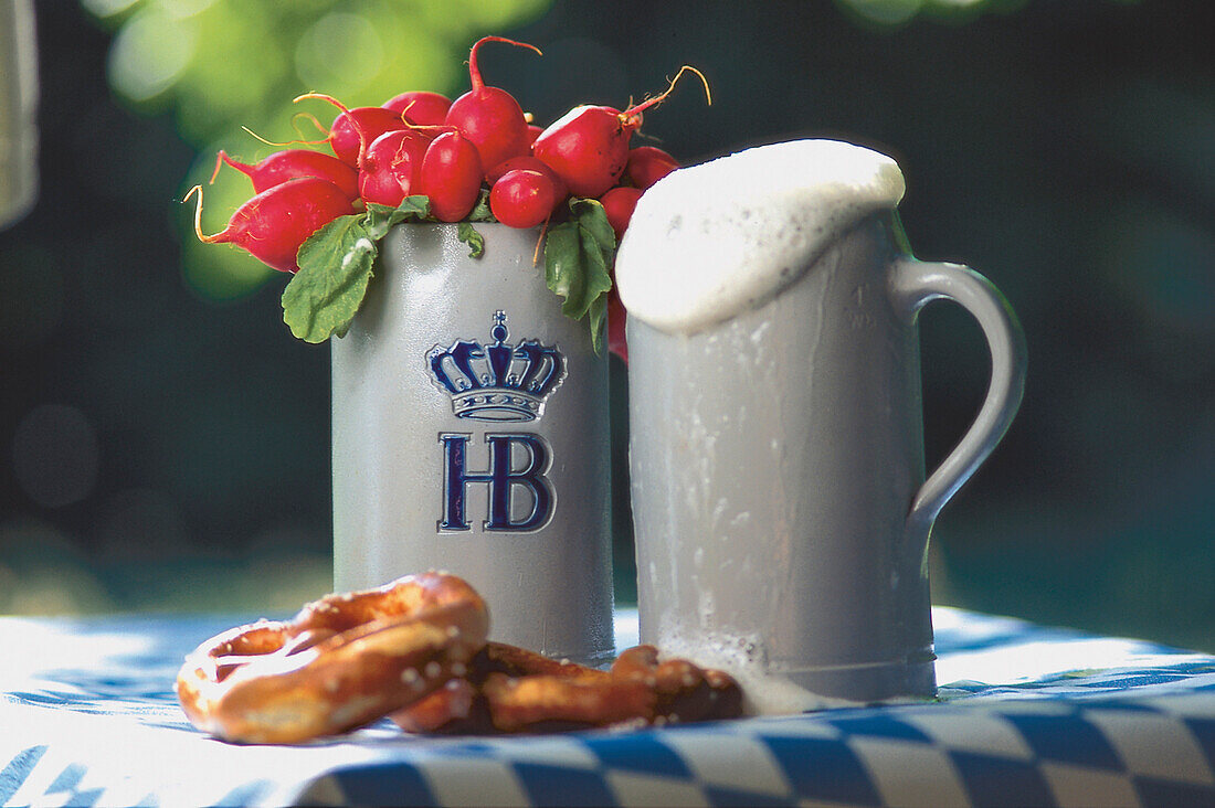Bavarian snack, two beer mugs and pretzels on a table, Bavaria, Germany, Europe