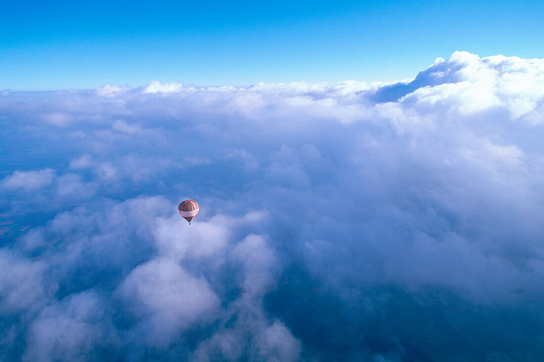 Hot air balloon over the clouds, Upper Bavaria, Germany