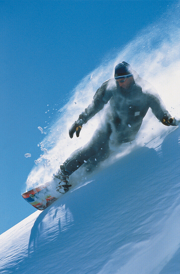 Snowboarder in powder snow, snowboarding down a slope, Winter Sports