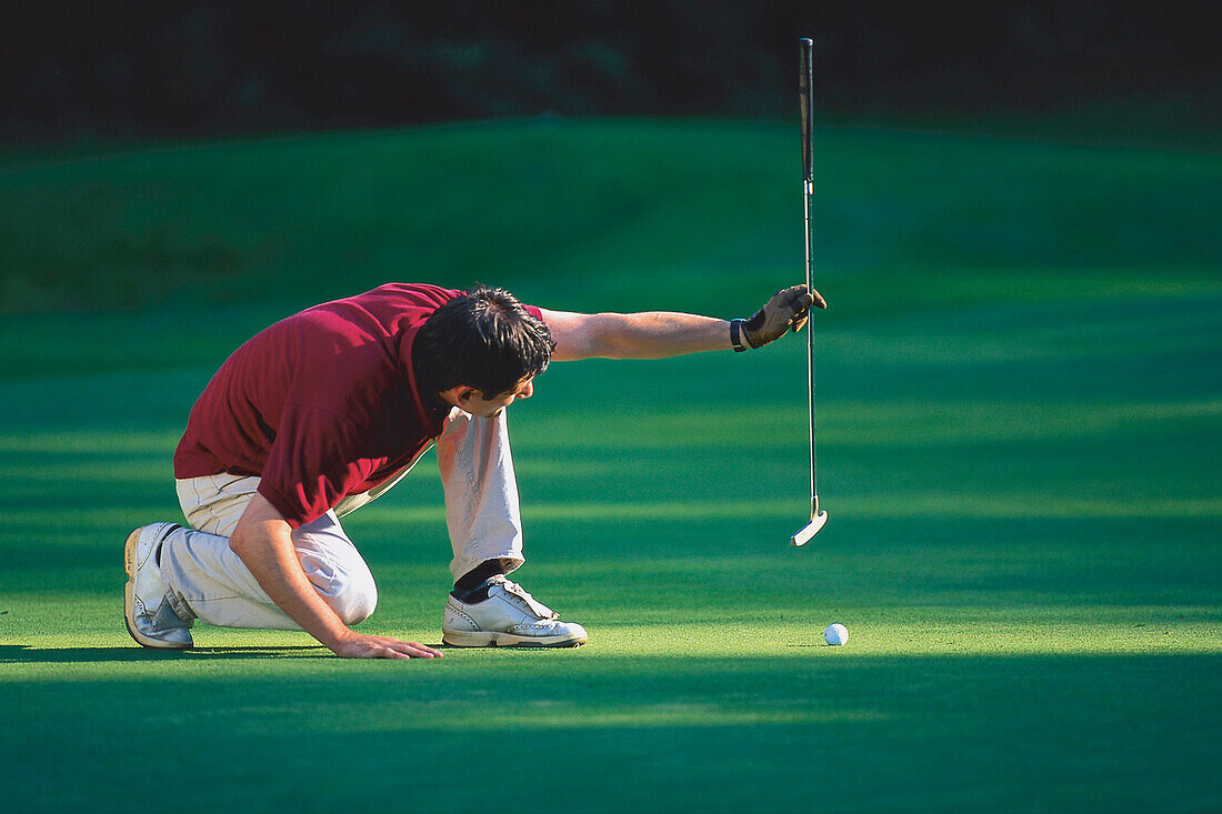 Male Golfer preparing