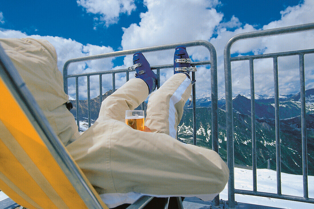 Skier relaxing and drinking beer