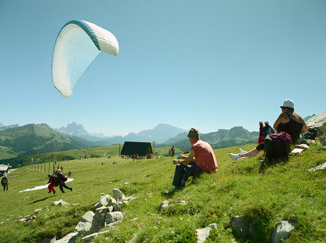 Paragliding, Start tandem leap, near Corvara, Dolomites, Alta Badia South Tyrol. Italy