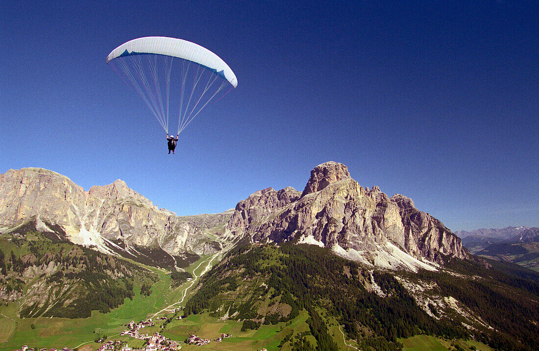 Paragliding over Corvara, Sassongher right side, Dolomites, Alta Badia South Tyrol. Italy