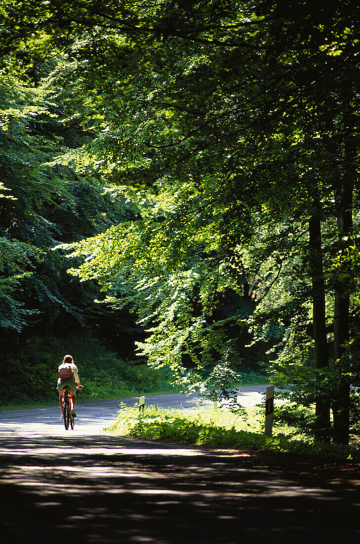 Cycling young woman, Jasmund Nationalpark, Ruegen, Germany