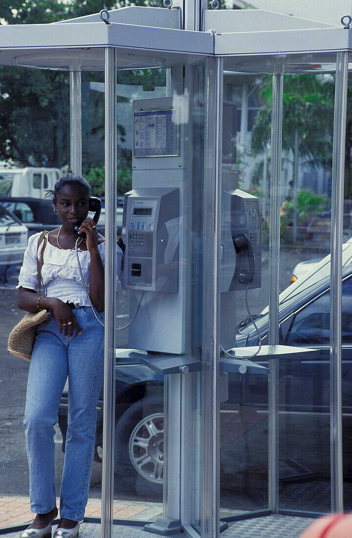 Woman in telephon box, Guadeloupe, Caribbean America