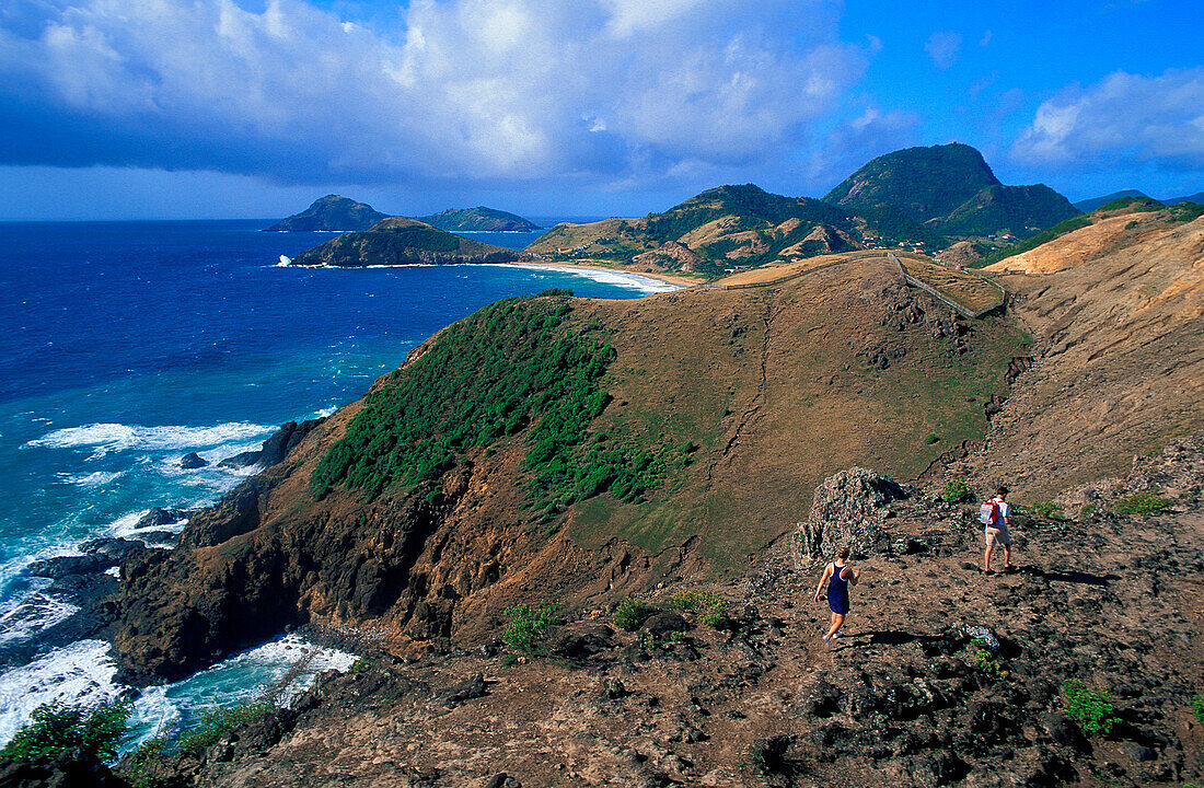 Two hikers above the coast, Anse a Cointe, Iles des Saintes, Guadeloupe, Caribbean, America