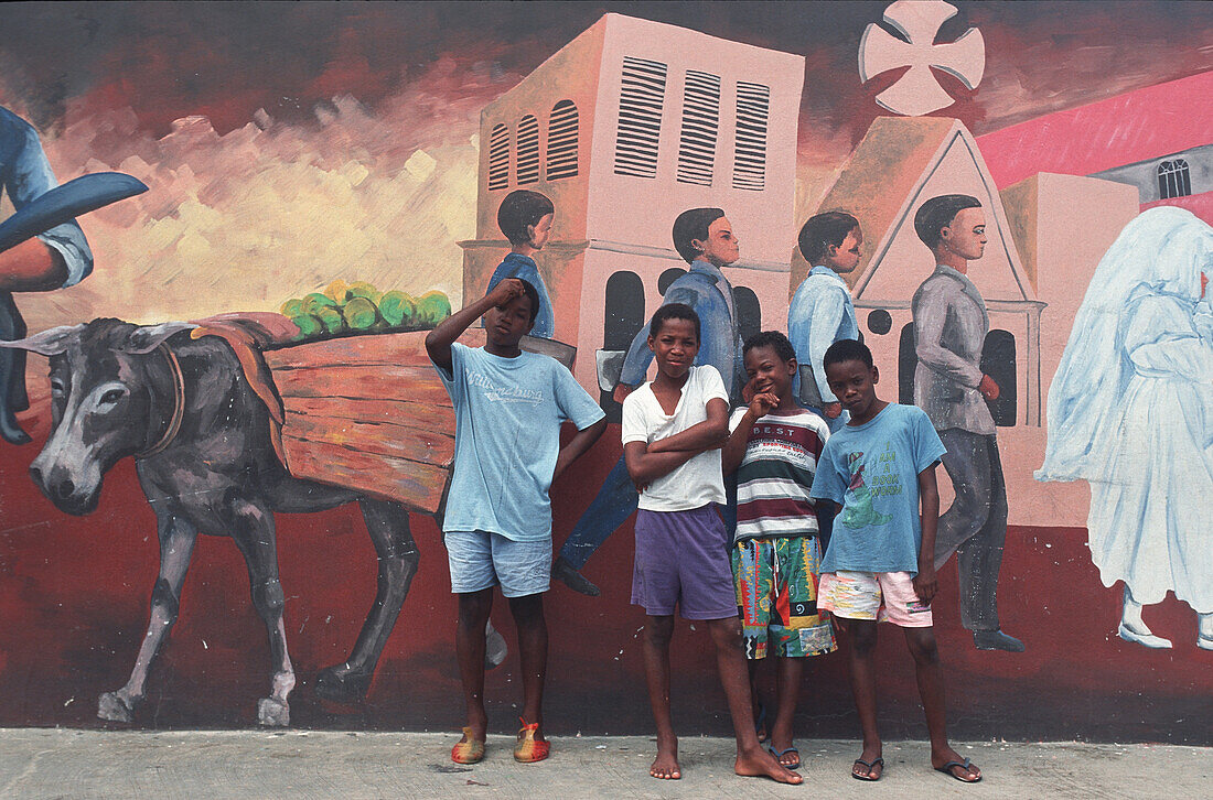 Four boys in front of graffitti in Castries, St. Lucia, Caribbean