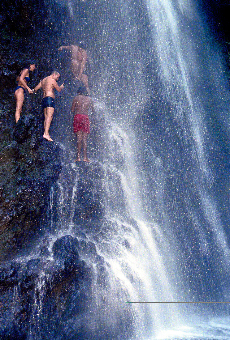 People climping through waterfall, Falls of Balleine, St. Vincent, Caribbean