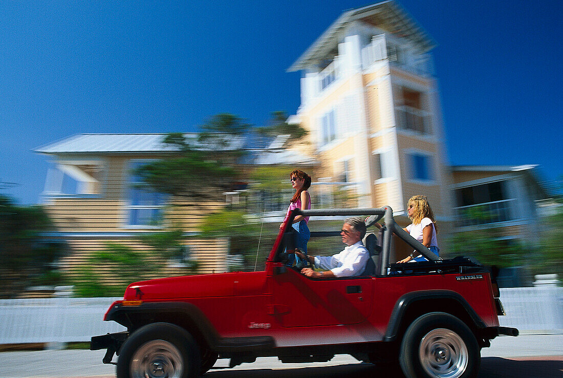 Young people in a jeep, Santa Rosa Island Florida, USA