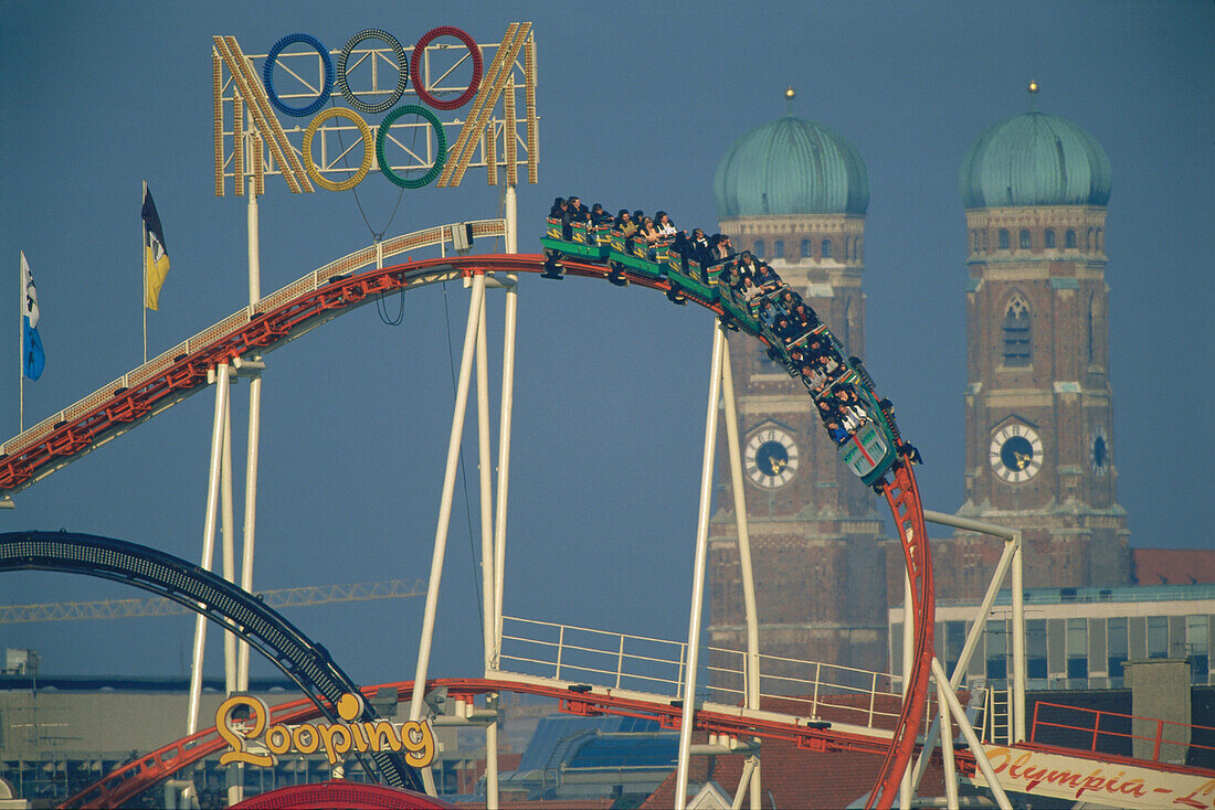 Roller coaster in front of Church of Our Lady, Oktoberfest Munich, Bavaria, Germany