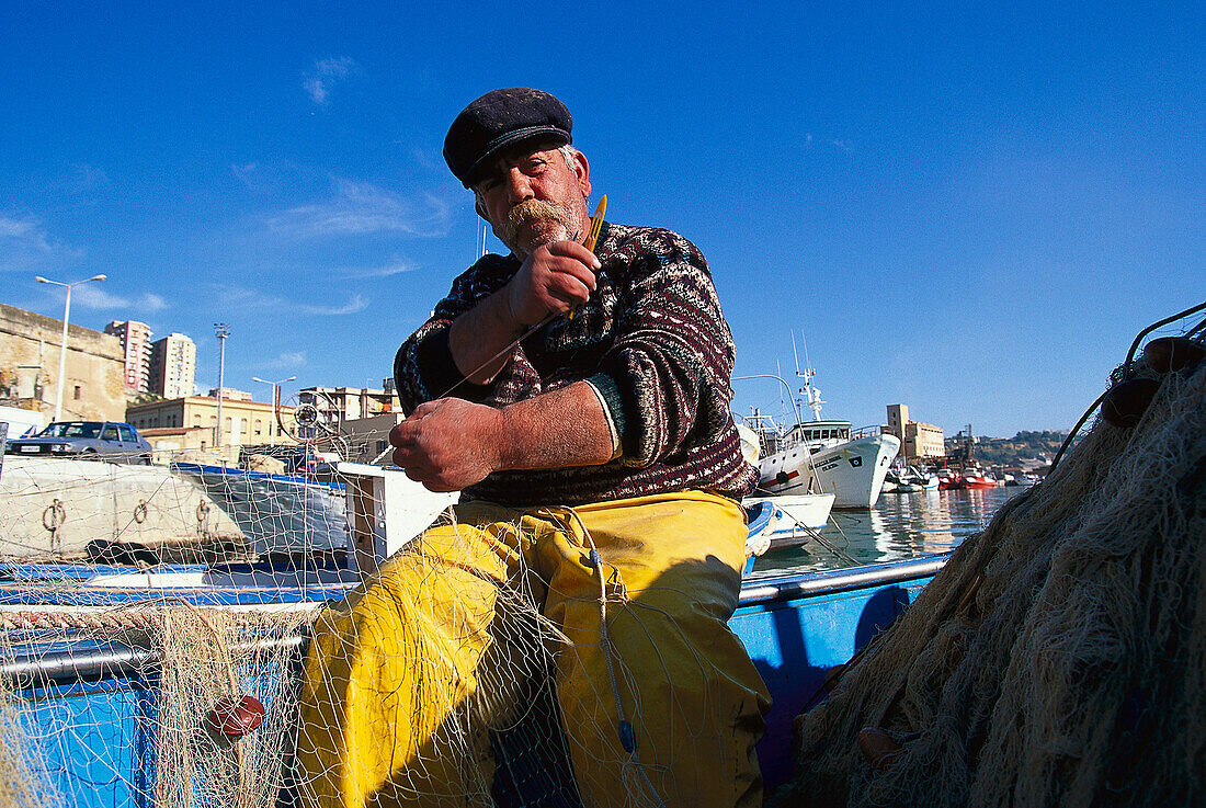 Giuseppe Roselli, 52, fisherman since 40 years, repairing nets, Agrigento, Sicily, Italy, Europe