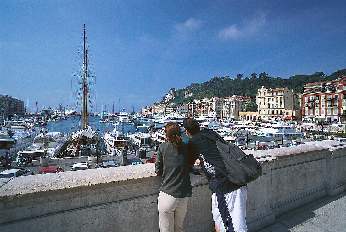 Couple admiring the view across Nice harbour, Nice, Cote D'Azur, France