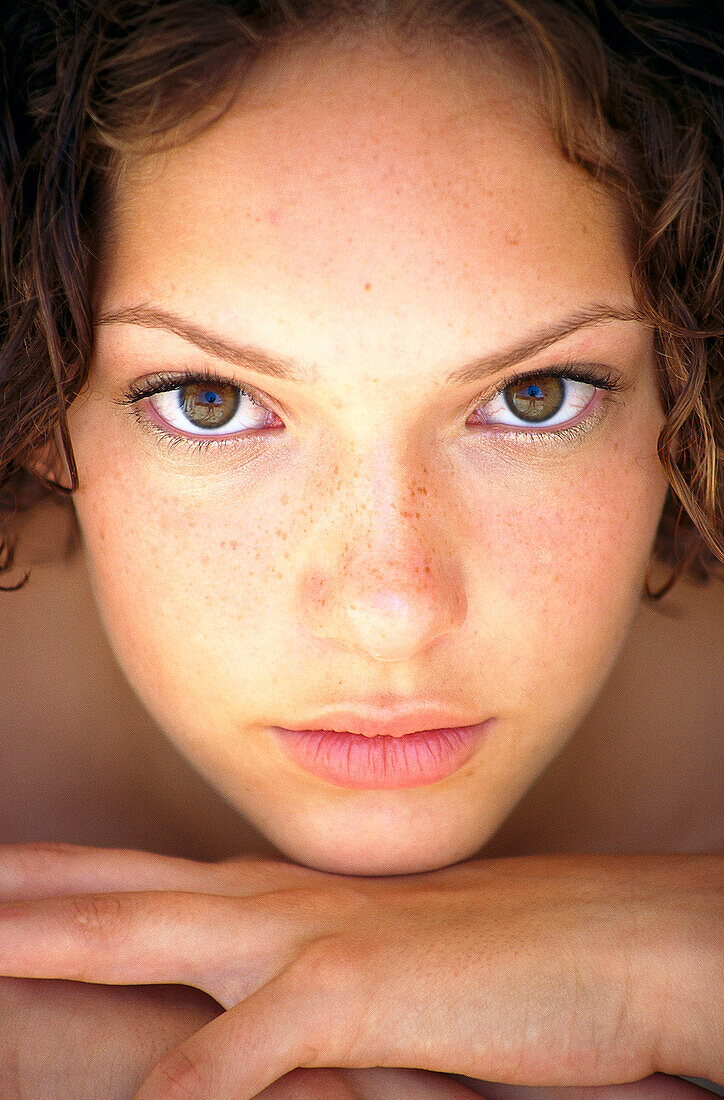 Portrait of a young woman looking into camera