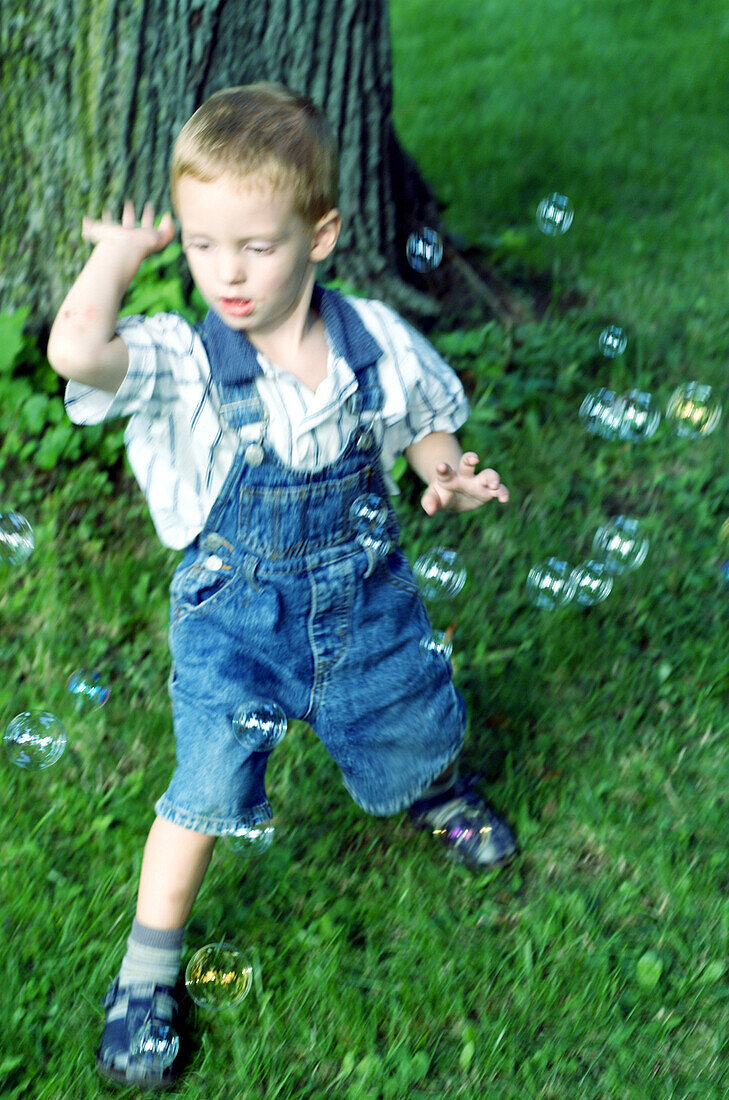 Boy playing with soap bubbles