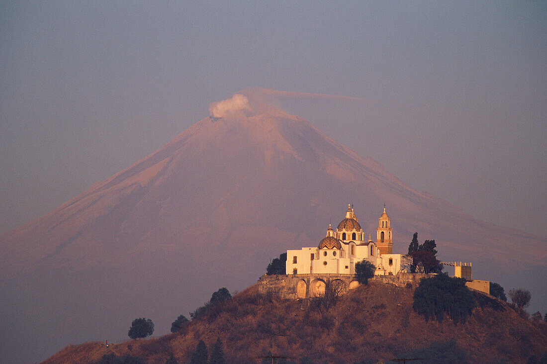 Church of Cholula and Popocatepetl volcano in the evening sun, Mexico, America