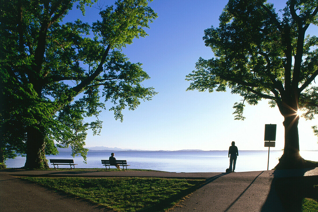 Two people at lake Chiemsee, Chieming, Upper Bavaria, Germany