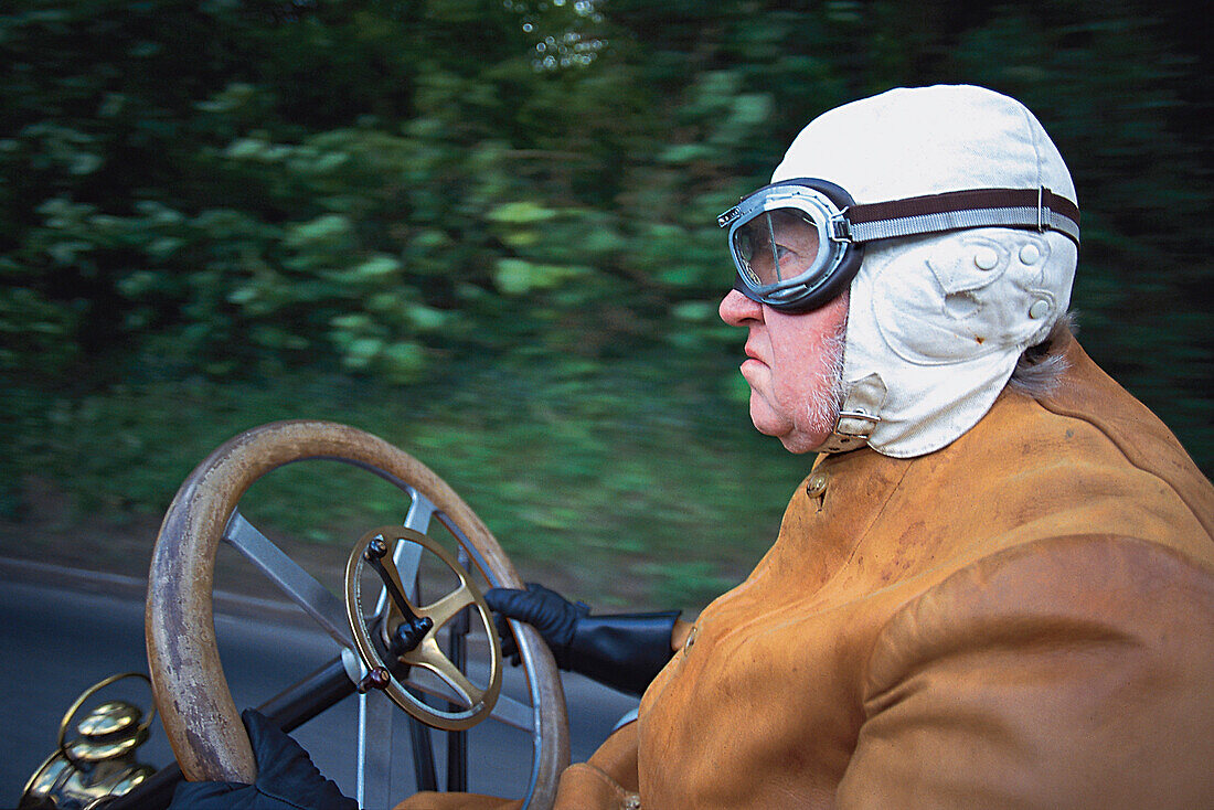 Old man riding a vintage car, Eastbourne, Sussex, Great Britain