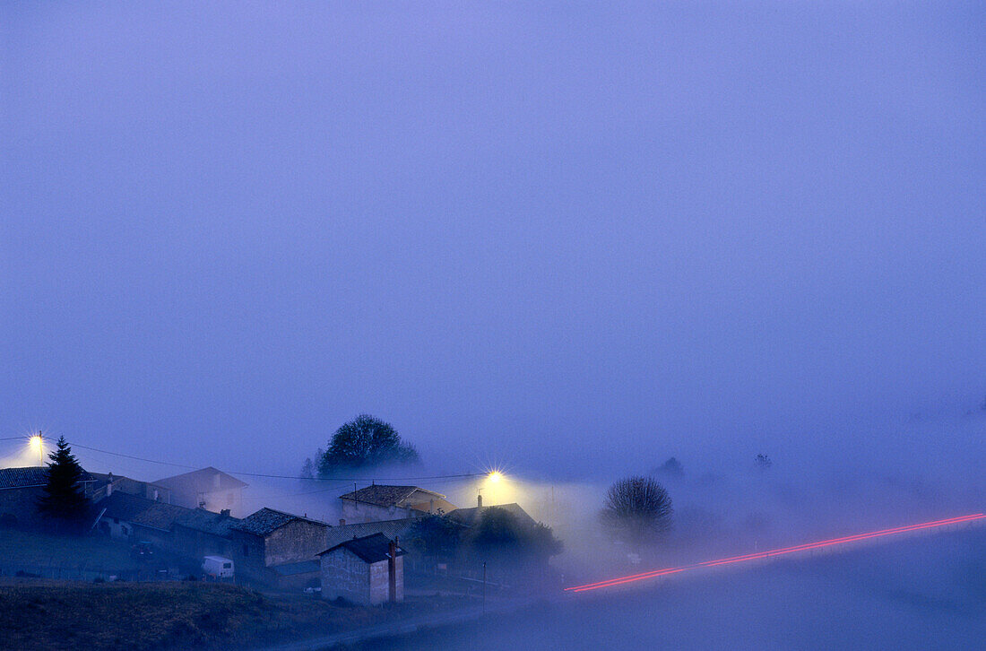 Village at Co du Fut d'Avenas in the fog, Beaujolais, France