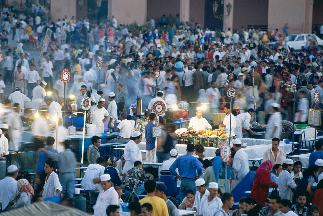Crowd and cookshops on the Nightmarket, Djemaa el-Fna, Marrakech, Morocco