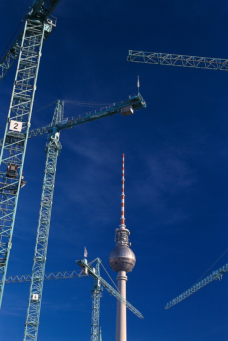 Construction cranes, Television Tower East Berlin, Germany