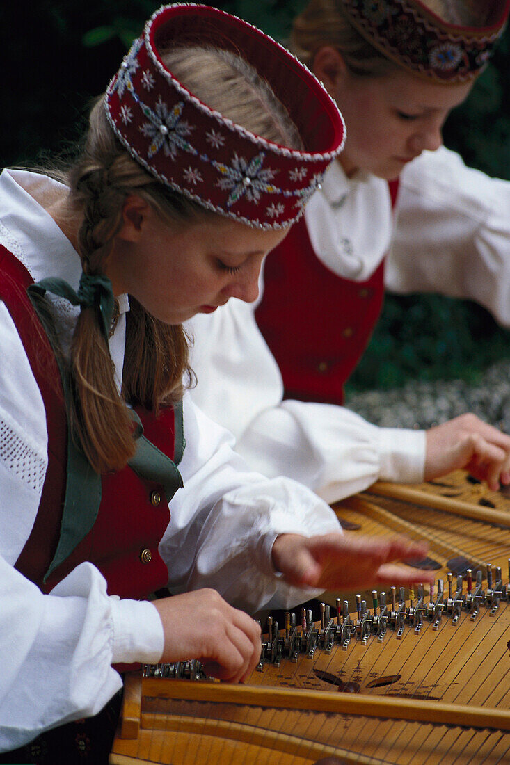 Two young women in traditional Danish clothes playing folk music, Jutland, Denmark