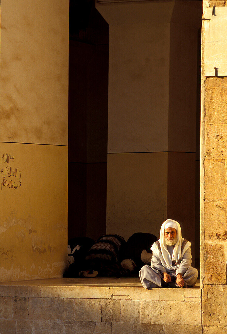 Man sitting in front of the Omayyaden Mosque, Aleppo, Syria
