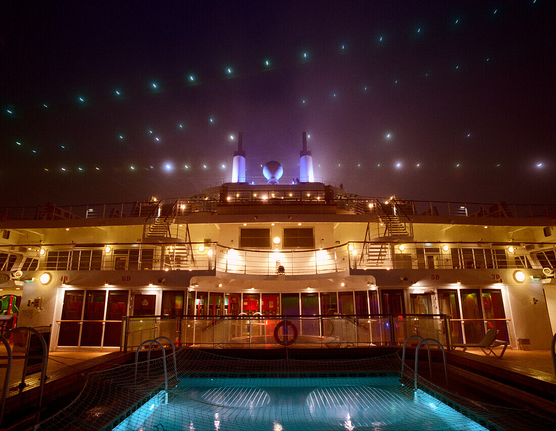 Illuminated deck and pool, Cruise ship Queen Mary 2