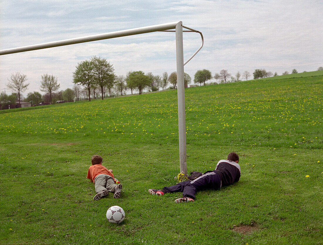 Boys playing soccer, Eifel, Germany