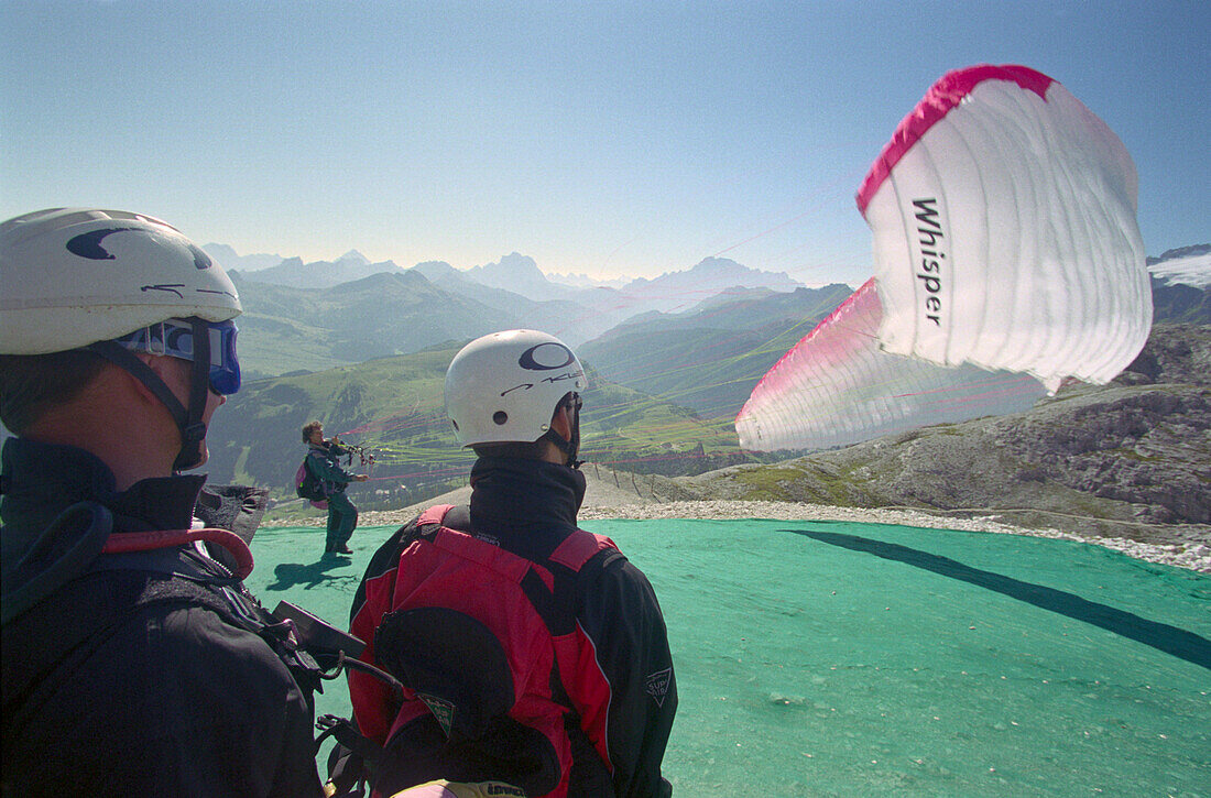 In preparation for paragliding, near Corvara, Dolomites, Alta Badia South Tyrol. Italy