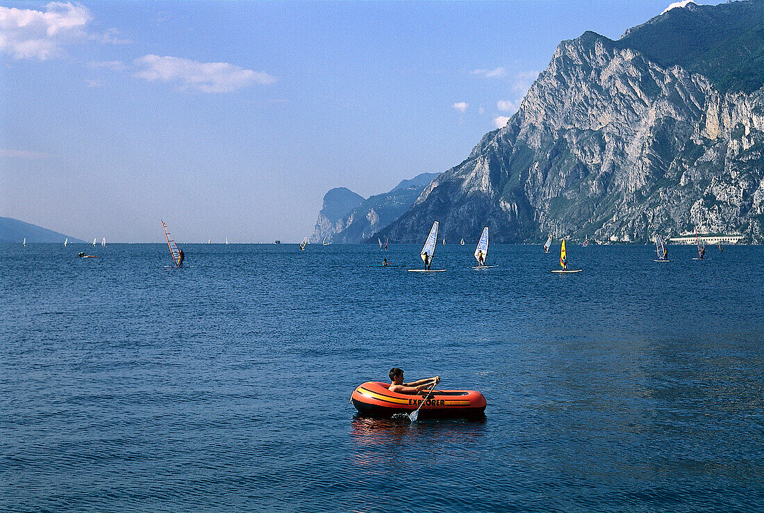 Child in a rubber dinghy on a lake, Torbole, Lago di Garda, Trentino, Italy, Europe