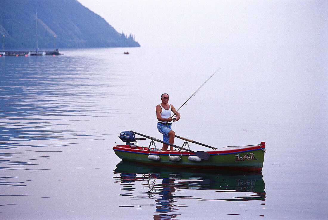 Fisherman in a Rowing Boat, Torbole, Lago di Garda Trentino, Italy