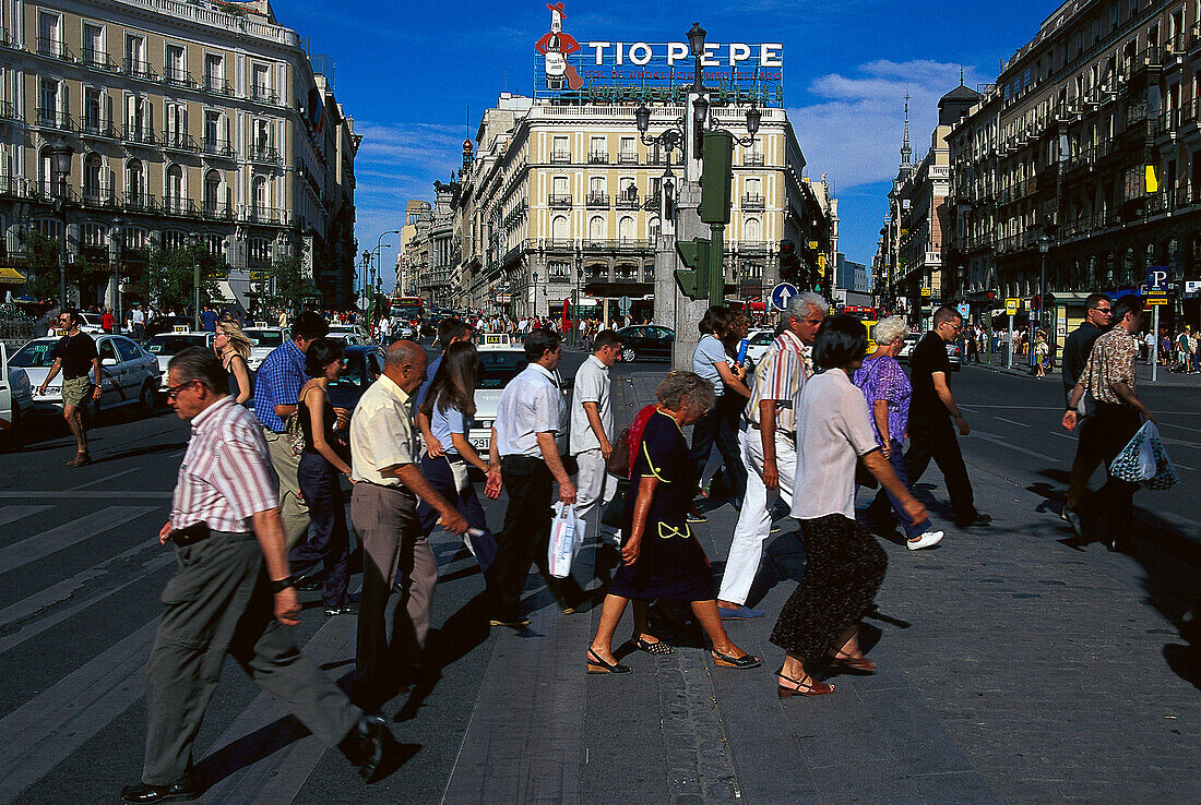 People crossing a road at Puerta del Sol, Madrid, Spain, Europe