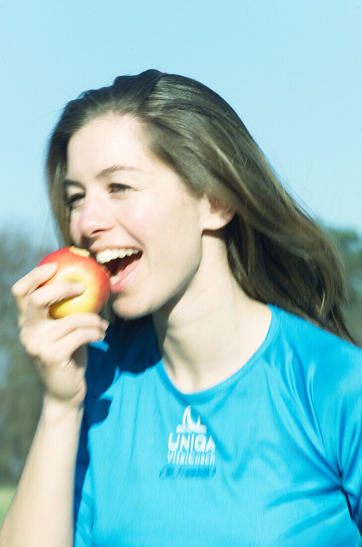 Woman eating apple, people eating