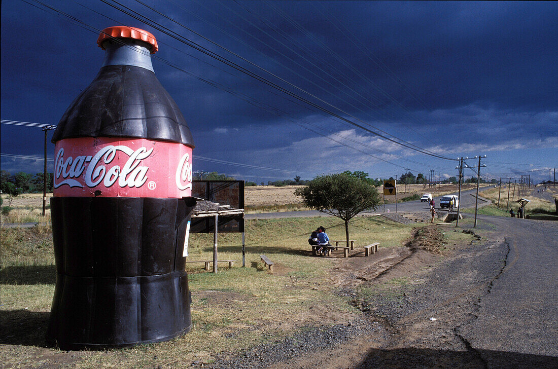 Big bottle as advertising, landscape on street