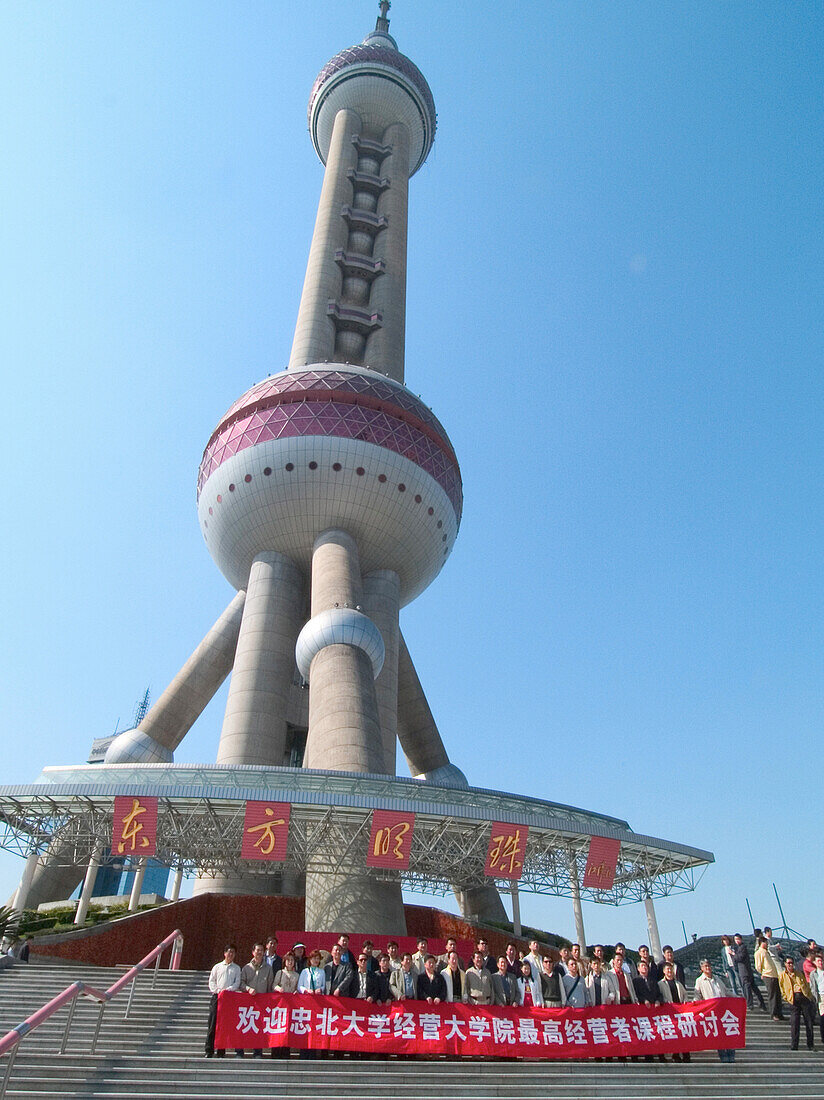 Tourists in front of the Pearltower, 468 m, built by architect Jia Huan Cheng and Shanghai Modern Architectural Design Co. Ltd., Pudong, Shanghai, China, Asia