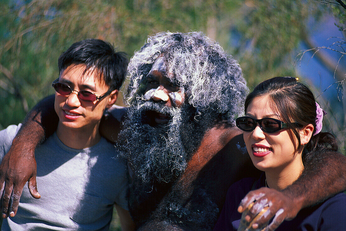 Aborigine posing with two Japanese tourists, Katoomba, Echo Point, New South Wales, Australia
