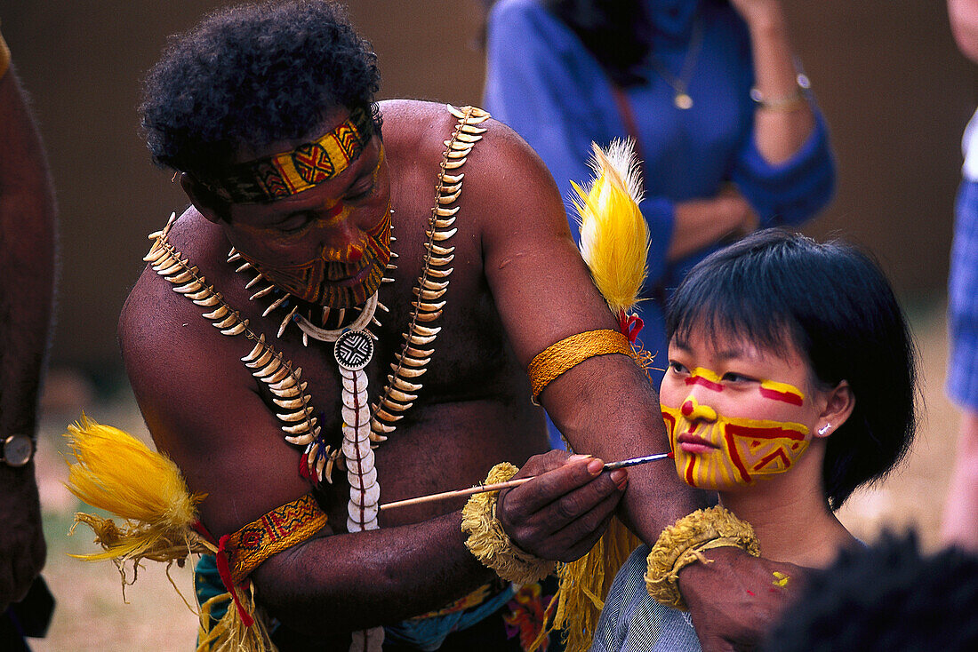 Aborigine painting the face of an Asian girl, Face paints, Royal Easter Show, Sydney, NSW, Australia