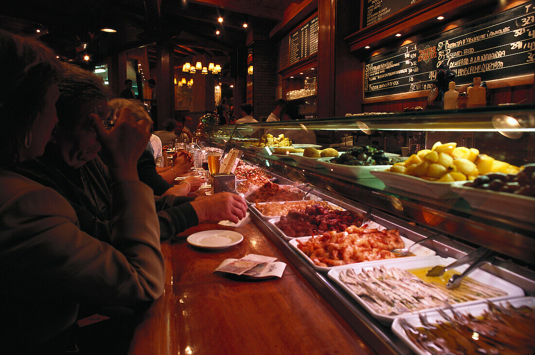 Tapas bar mit Kunden am Abend, Barcelona, Spanien