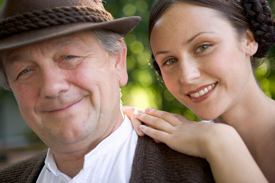 Mature man with young woman in beergarden near Lake Starnberg, Bavaria, Germany