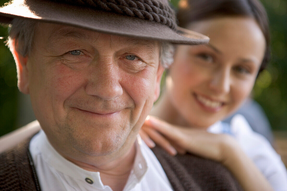 Mature man with young woman in beergarden near Lake Starnberg, Bavaria, Germany