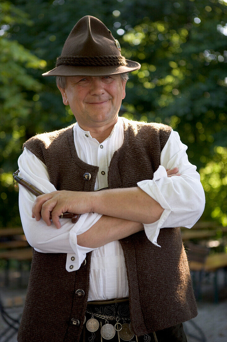 Older Bavarian man with pipe wearing traditional clothes, Munich, Bavaria