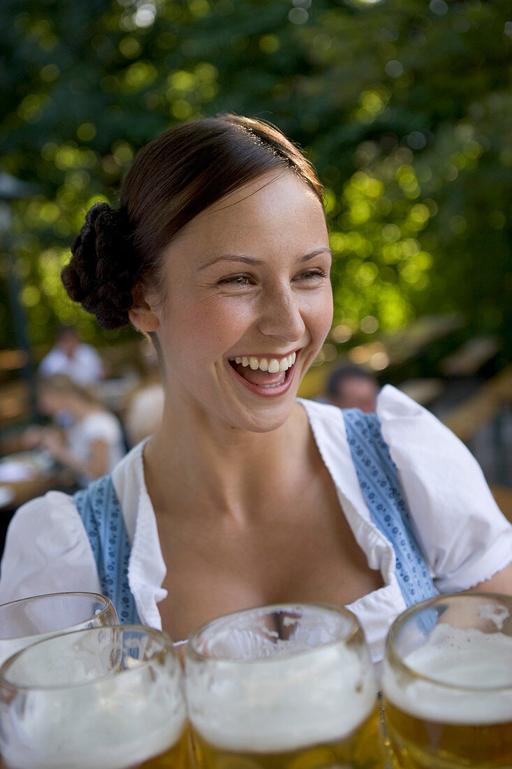 Young waitress in beer garden, Munich, Bavaria