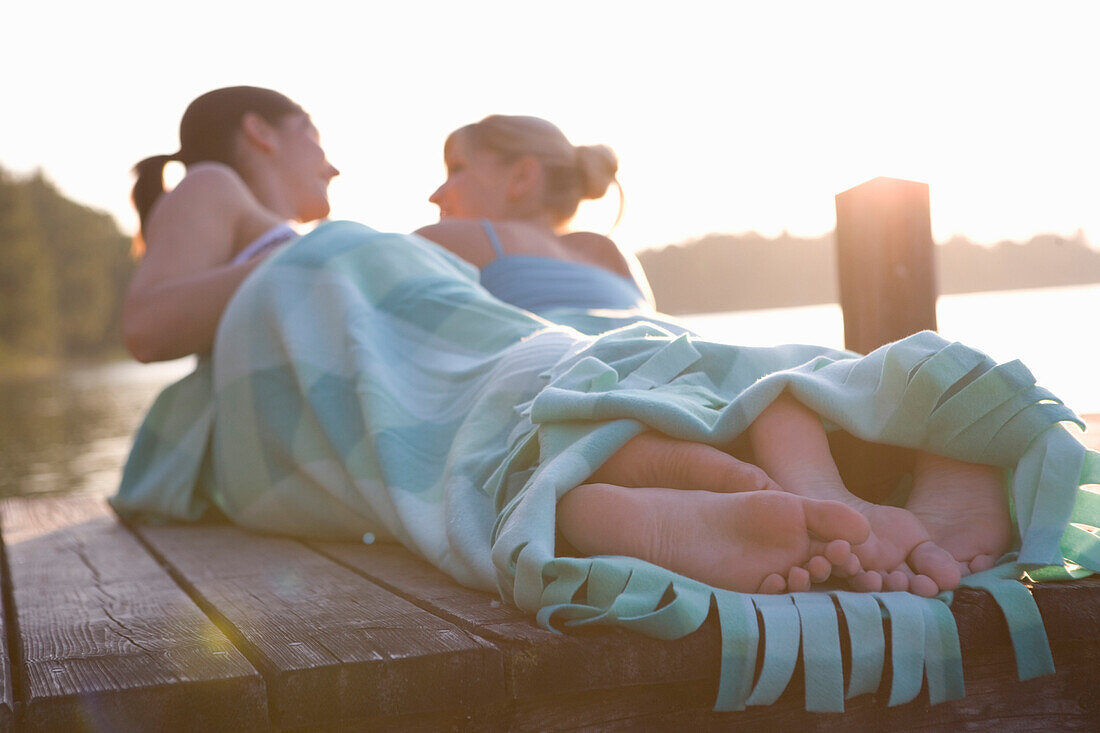 Girlfriends on footbridge, Starnberger See Bavaria, Germany